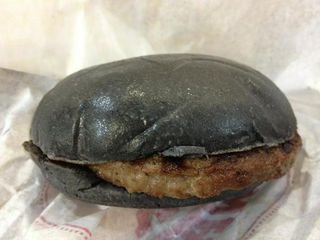 Illustration for article titled Burger King's all-black burger looks absolutely disgusting in real life